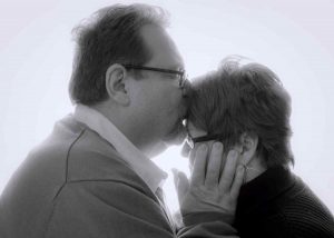 Black and white photo of Paul kissing Debbie.